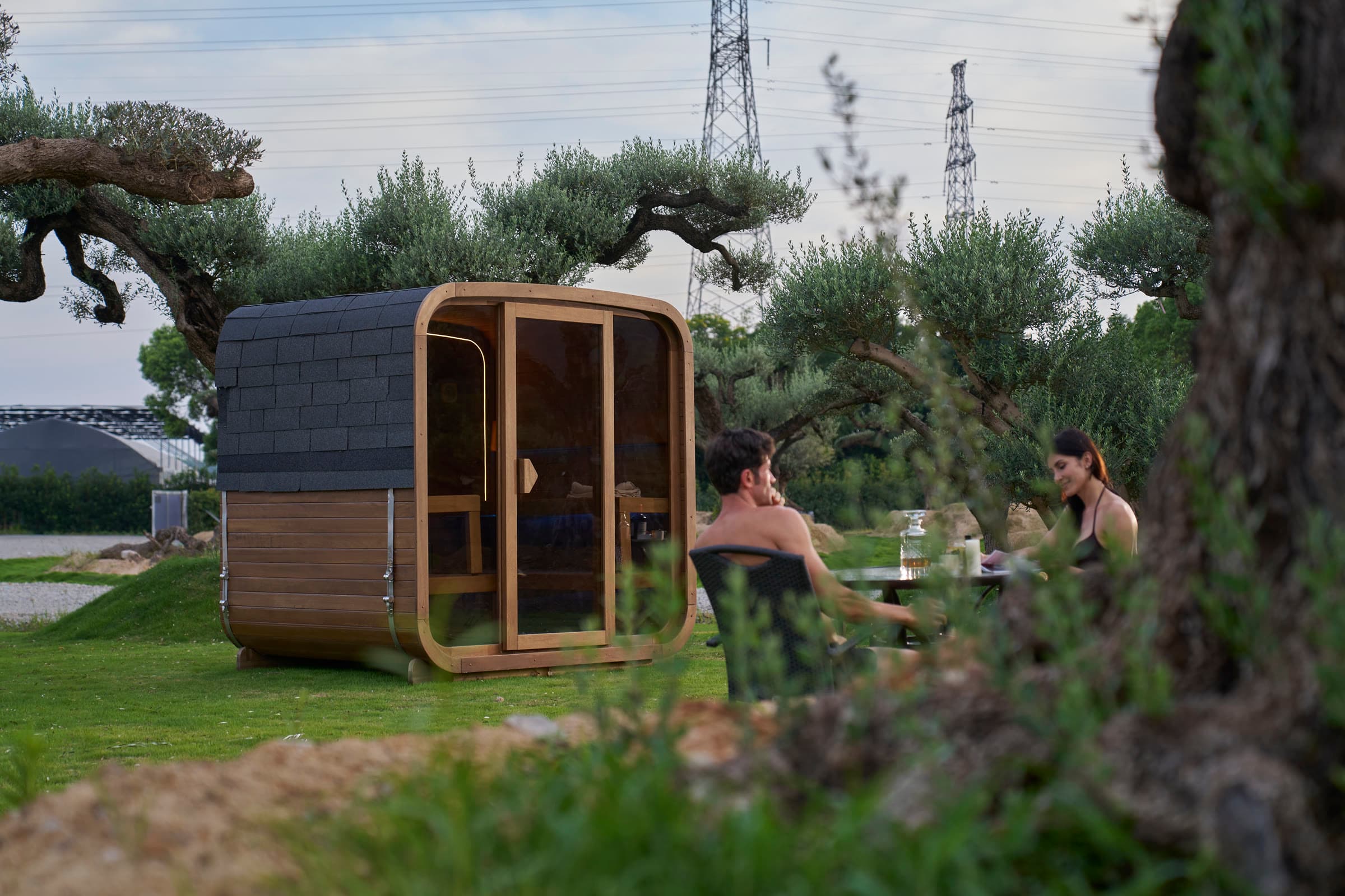 A panoramic-glass sauna at dusk